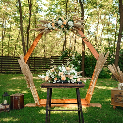 Rent wedding decor - arches, flowers, barrels.